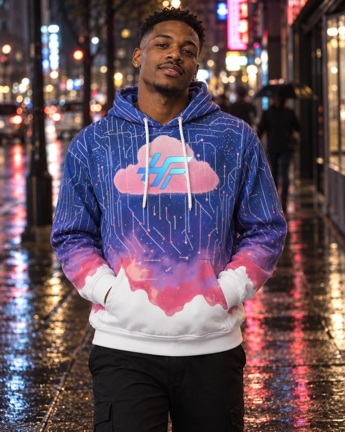 A man walking a wet city street at night, wearing the Cloud Hoodie