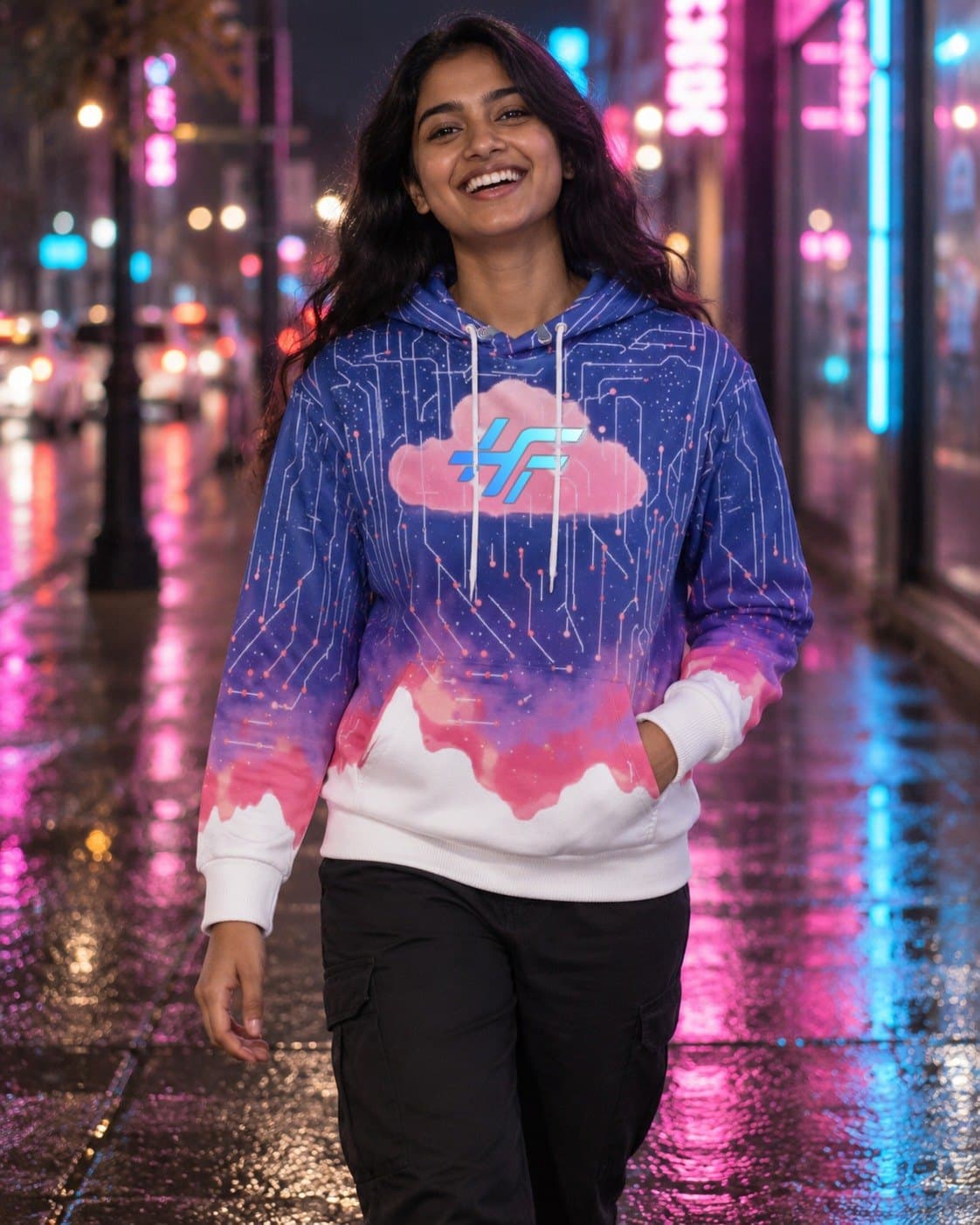 A woman laughing on a neon-lit street at night, wearing the Cloud Hoodie